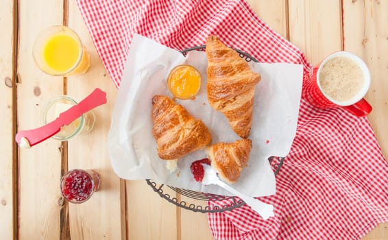 Fresh croissants with jams for breakfast