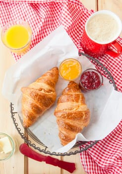 Fresh croissants with jams for breakfast