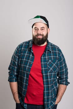 young bearded man with baseball cap is smiling