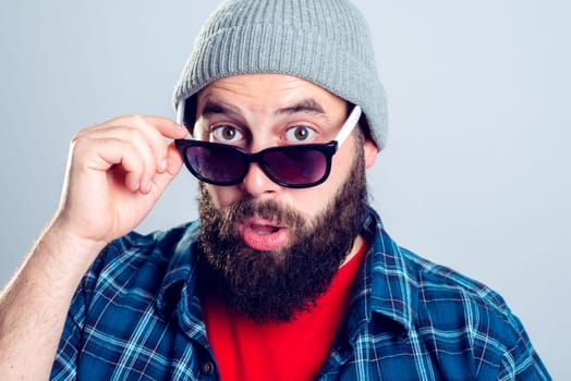 young bearded man lokking amazed in to the camera