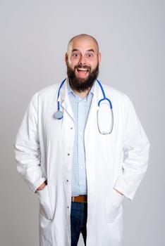 young bearded doctor in white coat looking amazed