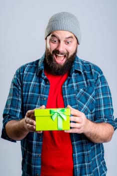 young bearded man with green gift box
