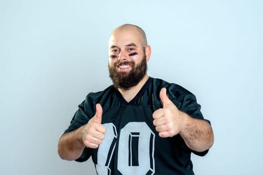 bearded american football player with thumbs up