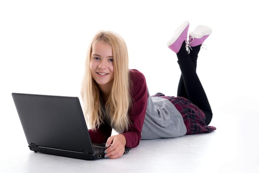 nice blond girl with laptop lying on the floor