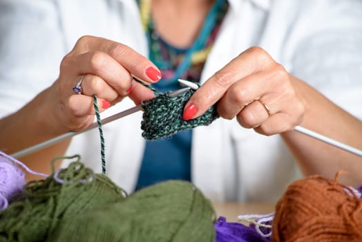 close up of the hands of a woman who knits