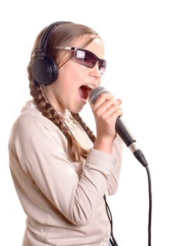 a young girl with headphones singing with a microphone