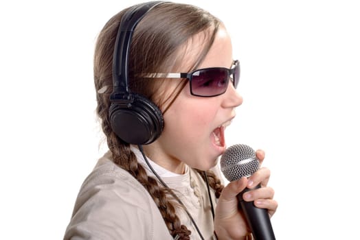 a young girl with headphones singing with a microphone