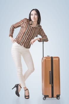 Modern Asian woman stand with a luggage.