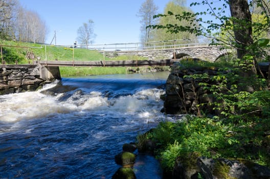 the water is streaming down in the river under the bridge