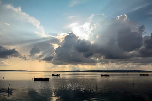 Sunset in the lagoon, where fishermen return to the approach of the impending storm. Dawning. Mediterranean islands.