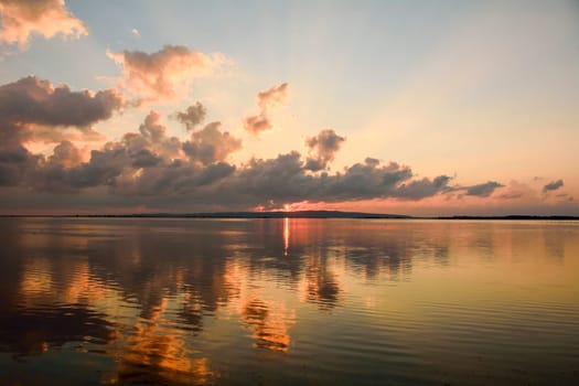 Sunset in the lagoon, where fishermen return to the approach of the impending storm. Dawning. Mediterranean islands.