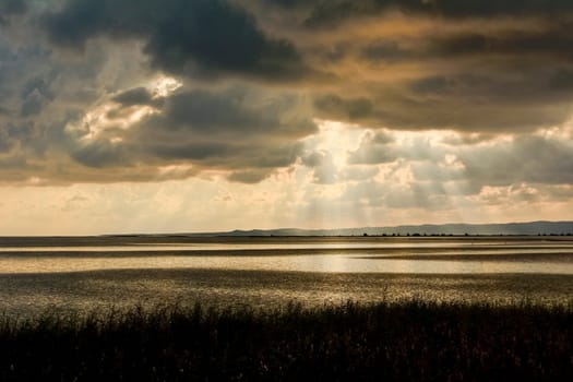 Sunset in the lagoon, where fishermen return to the approach of the impending storm. Dawning. Mediterranean islands.