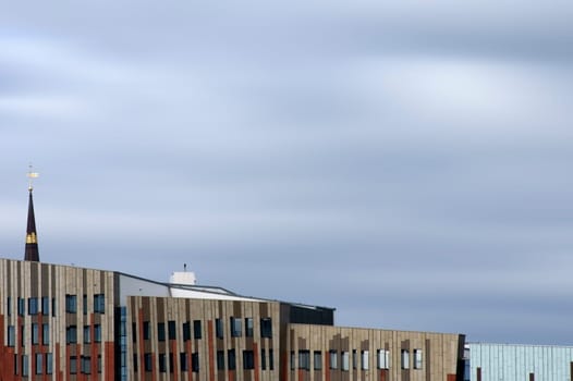 Hamburg,Germany - September 22,2014: Modern and abstract architecture in the port of Hamburg with the spire of St. Katharinenkirche above the roofs on September 22,2014 in Hamburg.