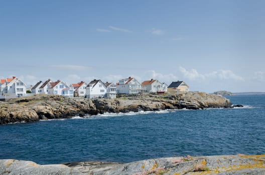 a little island on the swedish westcoast blue sky and it is blowing