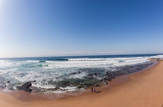 Family father mother child and young Son experience beach wave water ocean landscape