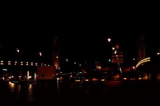 Paris,France - December 30,2013: The pontiff III bridge illuminated at night with road traffic and the illuminated Invalides Cathedral in the background on December 30,2013 in Paris.