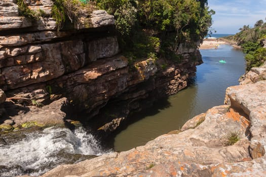 Rugged scenic beauty holiday destination of uvongo waterfall cliffs ravine lagoon beach ocean landscape