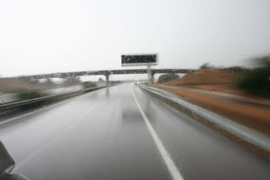 Driving heavy truck in bad weather conditions by highway. Slow shot
