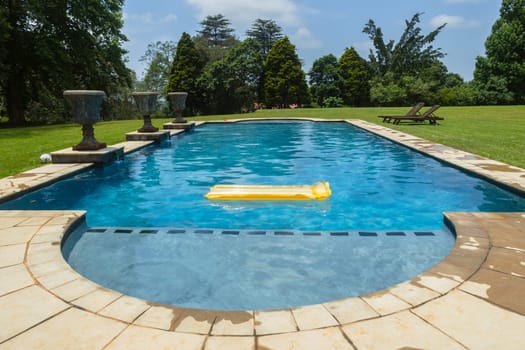Swimming pool blue water yellow air matt sunbath home private solitude.