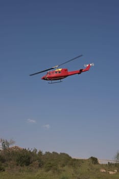 Yellow fire brigade helicopter on land, Spain