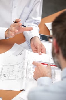 Architects gathered around plans
