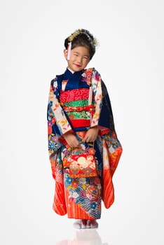 A cute young Japanese girl wearing a Kimono on a white background.