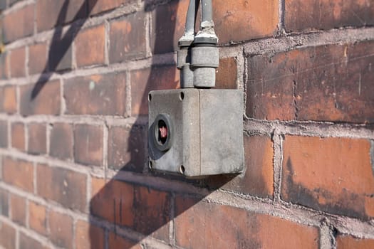 Emergency switch on the facade of a warehouse in the port of Magdeburg