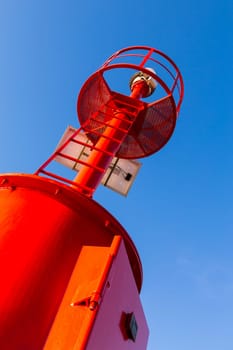 Bottom view and the diagonal of a lighthouse of a commercial port