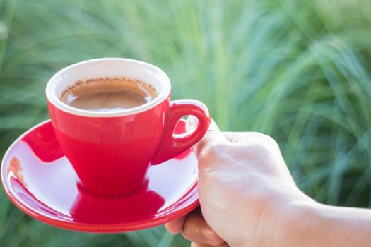 Woman holds a red coffee cup (vintage style color), stock photo
