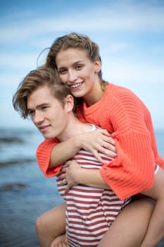 Portrait of a beautiful affectionate young couple at the beach. They look very content and happy together.