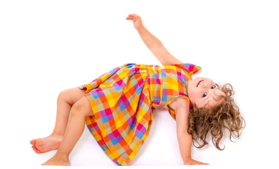 Little girl does gymnastics on white background.