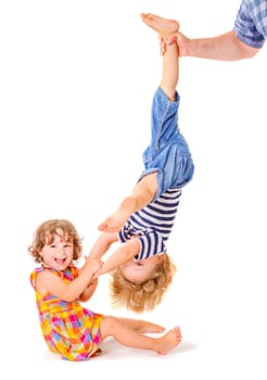 Happy little sister and brother playing together on white background