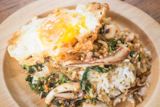 Rice topped with stir-fried squid basil and fried egg (Thai food), stock photo