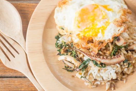 Rice topped with stir-fried squid basil and fried egg (Thai food), stock photo