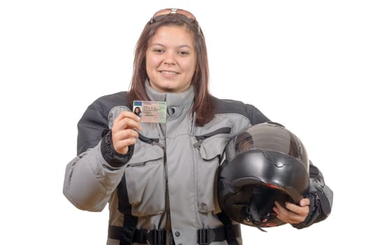 Happy young woman showing proudly her new motorcycle license on white