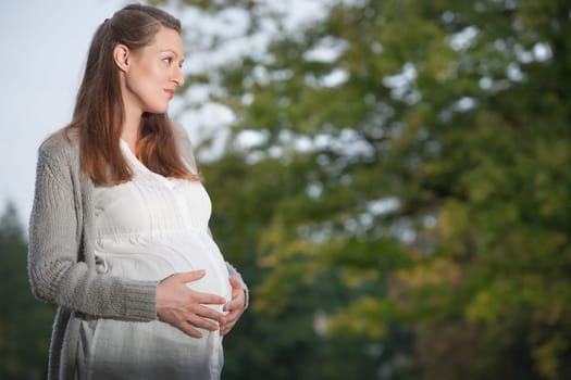 Young new mother is having fun outside