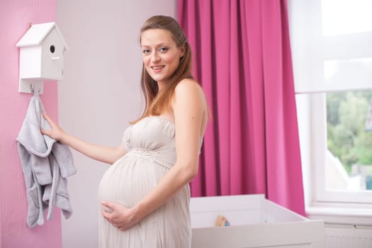 Young new mother in the new babyroom