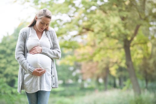 Young new mother is having fun outside