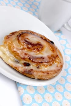 Raisin snail with white cup in the background