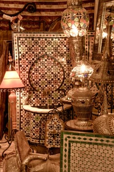 Background from shining arabic lamps and glazed tile fountains shop. Toledo, Spain