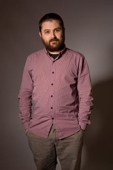 young casual man portrait in a dark background