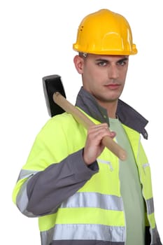 Labourer carrying a mallet