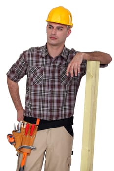 Worker resting on plank of wood