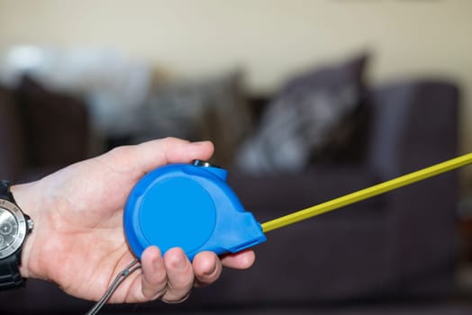 measuring tape in hand for do it yourself home improvements