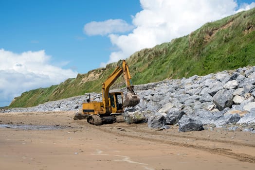 mechanical excavator working on coastal protection for the ballybunion golf course in ireland