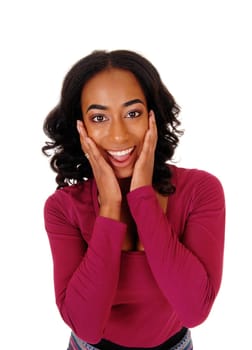 A lovely African American woman with long curly black hair holding her.hands on her face, smiling, isolated for white background..