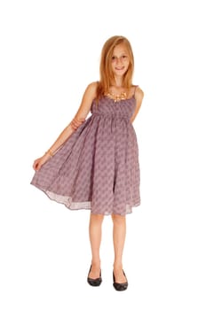 A young slim girl standing for white background in a burgundy dress.and lifting up her dress..