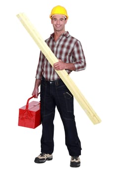 Tradesman holding a wooden plank