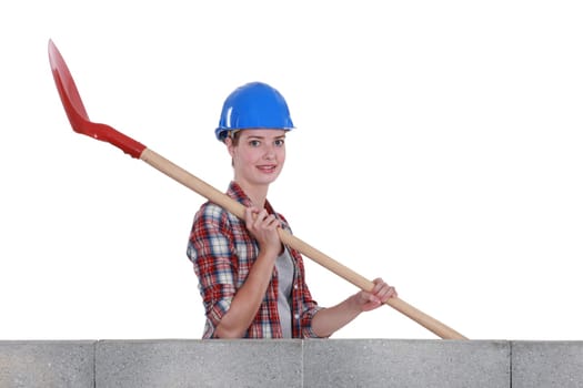 Female mason holding shovel