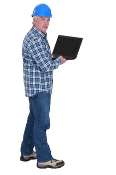 Senior worker holding laptop